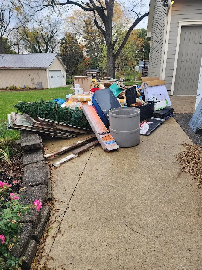 Dumpster being loaded with debris for Roofing Dumpster Rental in Taos